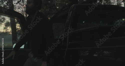Bearded man leaves pickup truck on a farm