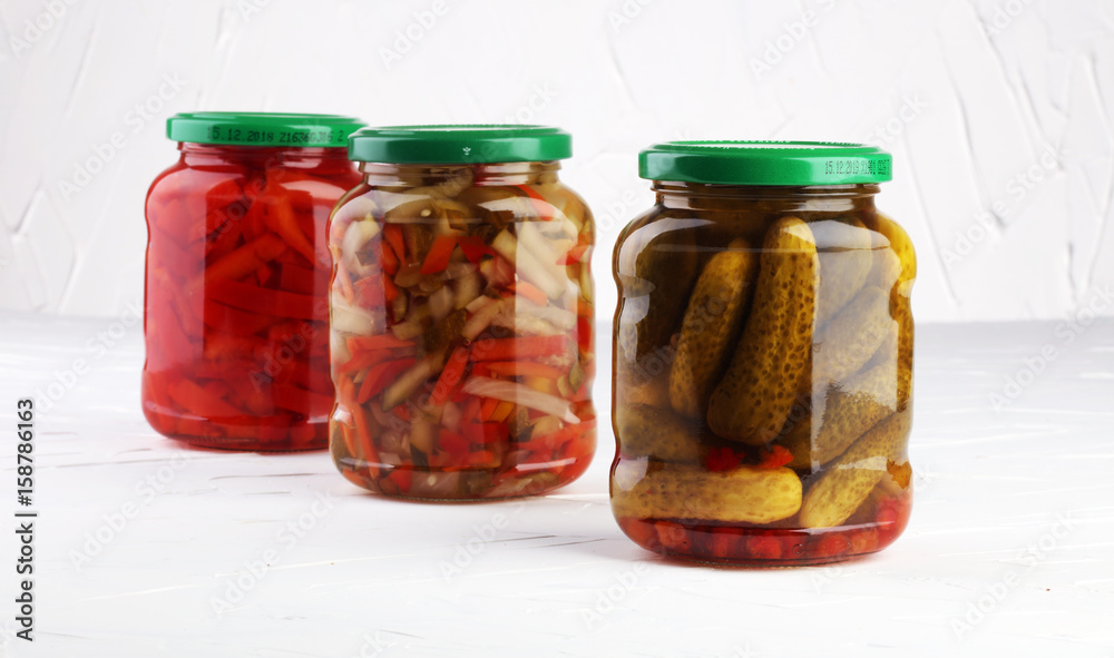 Jar with variety of pickled vegetables. Carrots, field garlic, cucumber in glas. Preserved food Jar with variety of pickled vegetables. Carrots, field garlic, cucumber in glas. Preserved food
