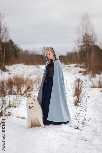 fantasy elf girl in spring forest with white dog laika