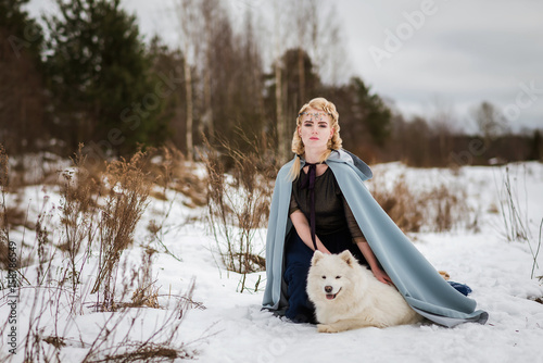 fantasy elf girl in spring forest with white dog laika
