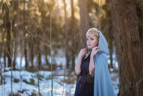 Fantasy elf girl in spring in a sunny forest