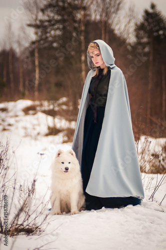 fantasy elf girl in spring forest with white dog laika