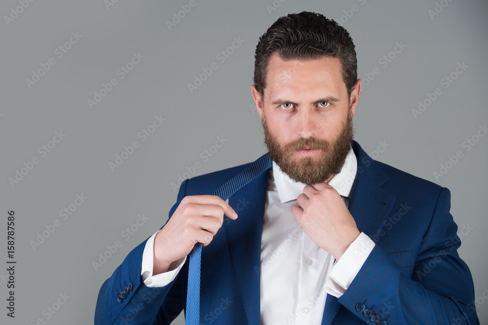 portrait of handsome serious business man on grey background portrait of handsome serious business man on grey background
