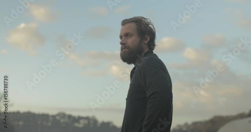 Gardener stands in organic farm at sunrise