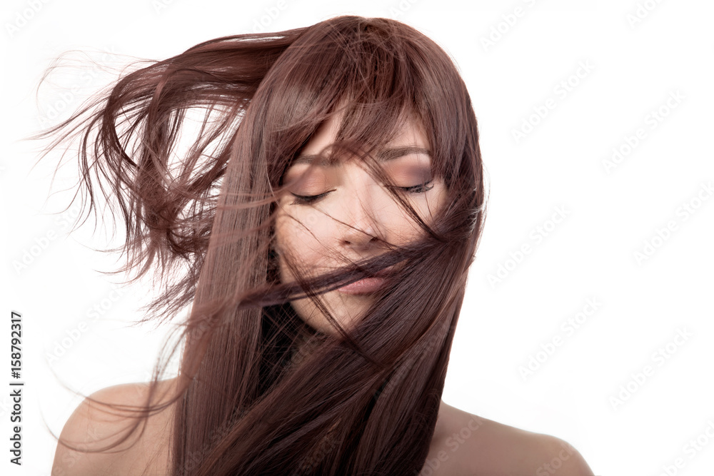 Brunette beauty girl. Healthy long hair flying over face Brunette beauty girl. Healthy long hair flying over face