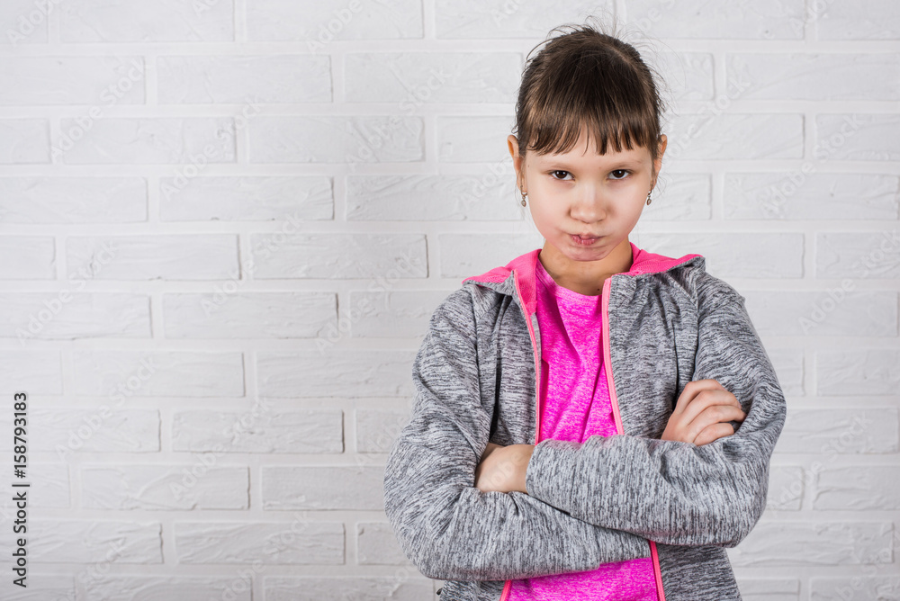 Young girl posing on a white background in the studio. Young girl posing on a white background in the studio.