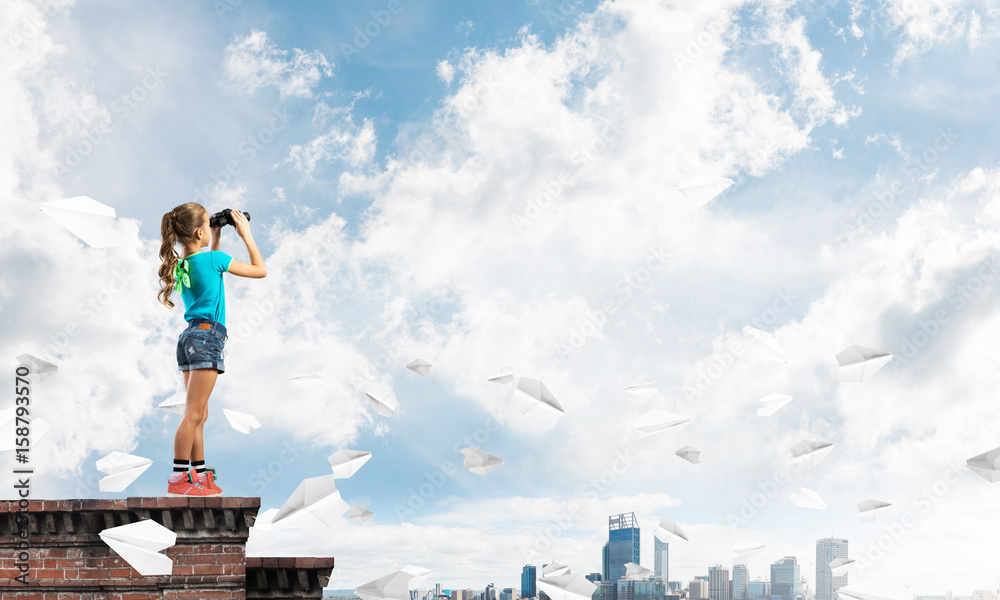 Concept of careless happy childhood with girl of school age looking in future Concept of careless happy childhood with girl of school age looking in future