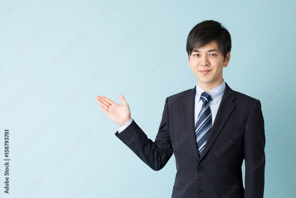 portrait of asian businessman indicating isolated on blue background portrait of asian businessman indicating isolated on blue background