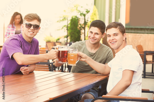 Guys drinking beer in pub