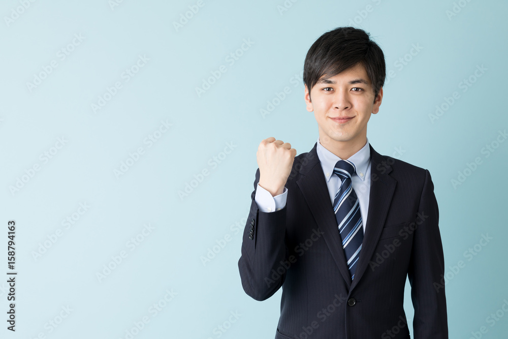 portrait of asian businessman isolated on blue background portrait of asian businessman isolated on blue background
