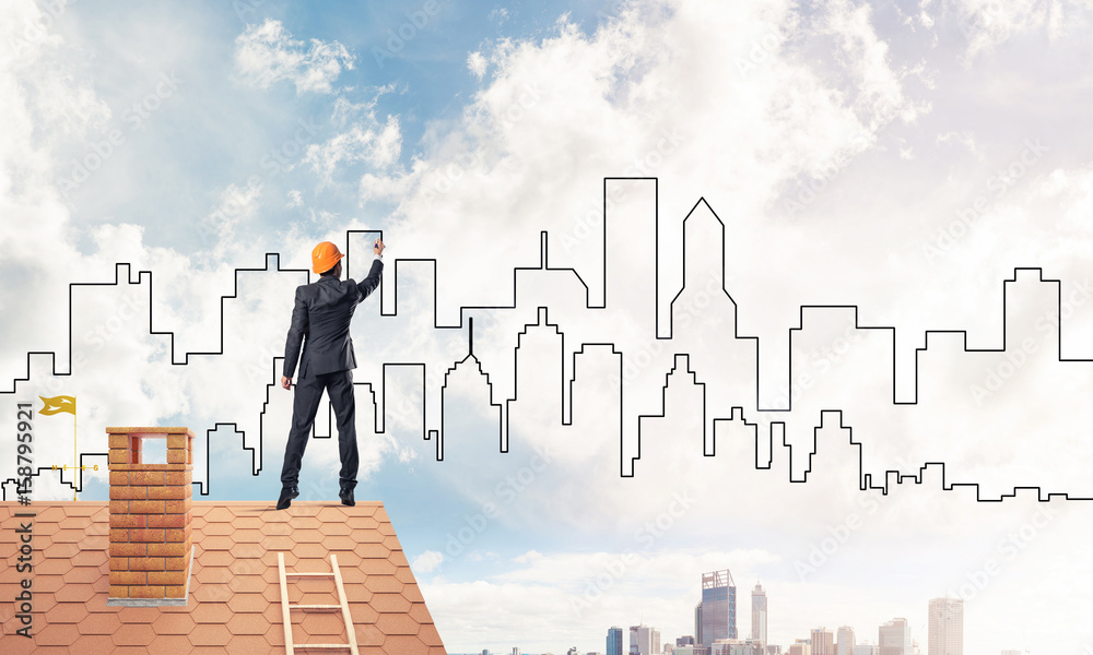 Man architect draw silhouette of modern city on blue sky. Mixed 