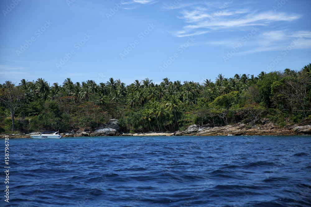 tropical blue sea and island with stone