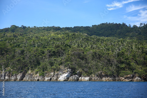 tropical blue sea and island with stone