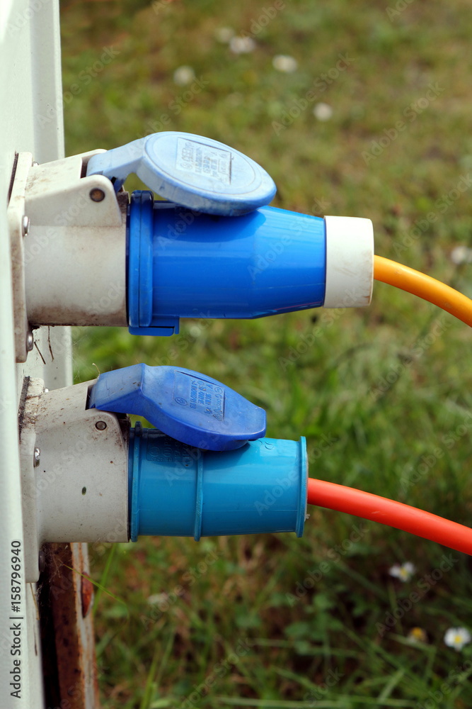 Two three pin outside power plugs connected to a campsite water and electricity supply point