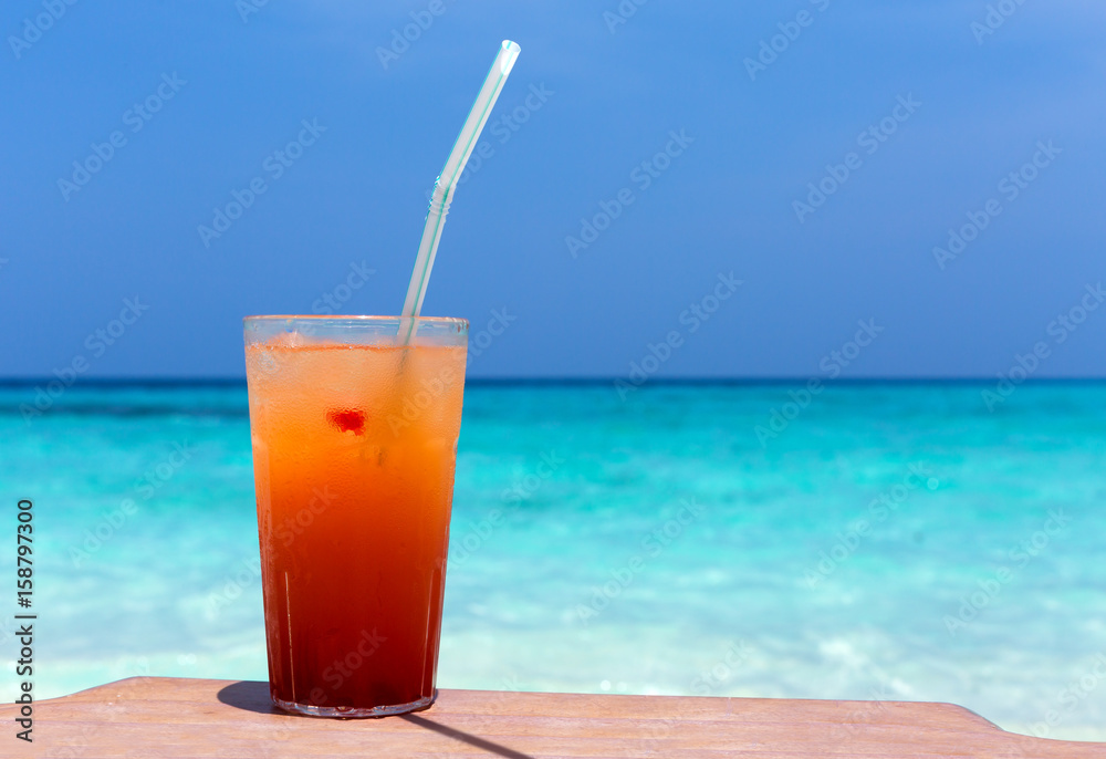 Cocktails in glass on white sandy beach Cocktails in glass on white sandy beach