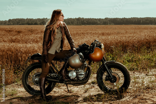 Woman rider with his vintage custom made cafe racer