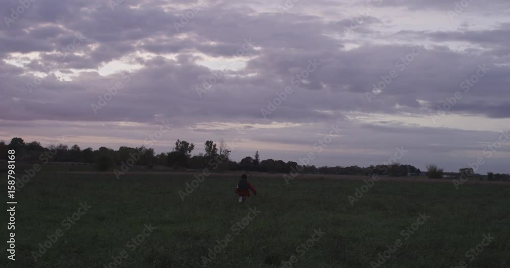 Little kid runs away in field, slow motion Little kid runs away in field, slow motion