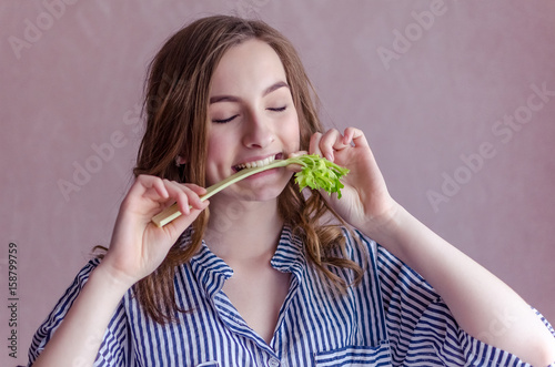 Beautiful girl eating celery
