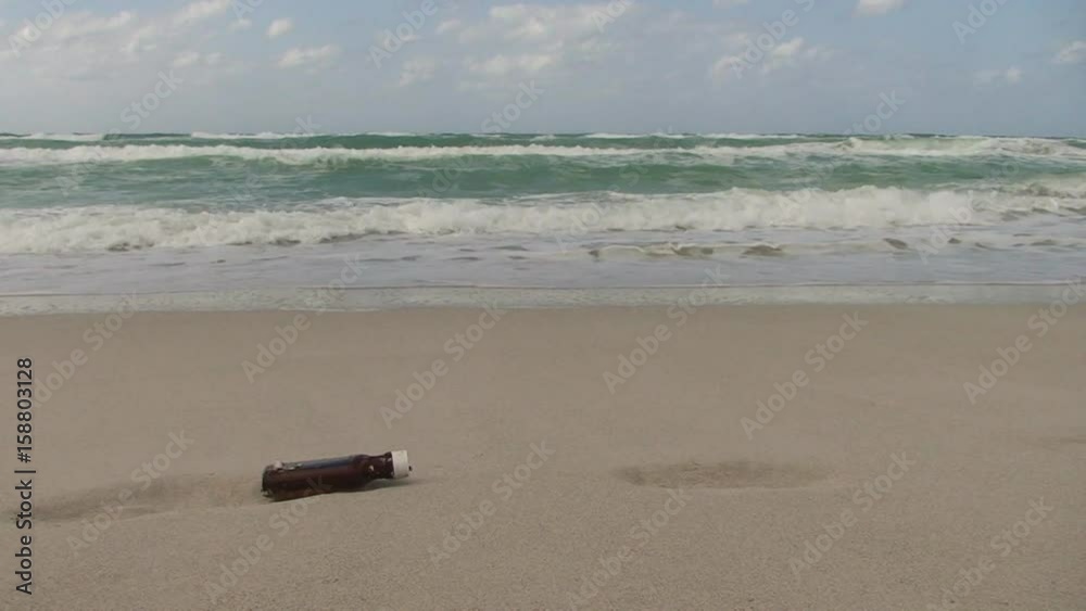 Empty plastic bottle sits on the beach Empty plastic bottle sits on the beach