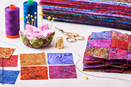 Sewing patchwork blocks to colorful batik quilt