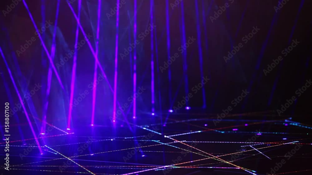 Blue abstract light effects background. Colorful rays flashes on the stage. Laser concert lighting