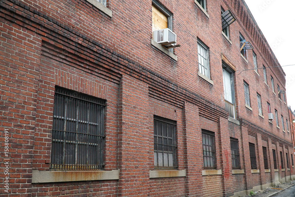 perspective view of brick wall and window of old factory building perspective view of brick wall and window of old factory building