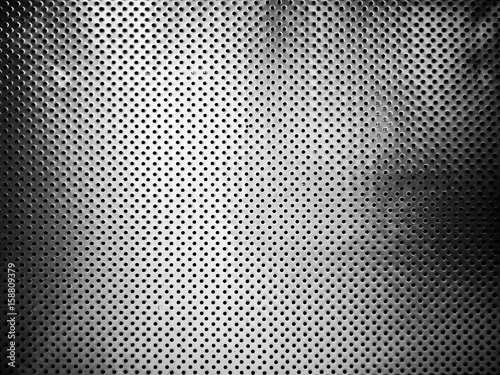 Perforated metal plate texture background vintage black and white tone filter