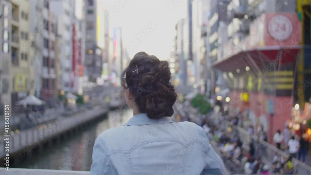 Young women looks over dotombori Bridge Namba Osaka Young women looks over dotombori Bridge Namba Osaka