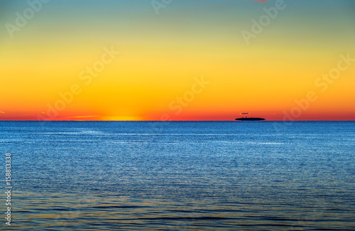Fototapeta Naklejka Na Ścianę i Meble -  Island Afloat on the Sound at Sunset
