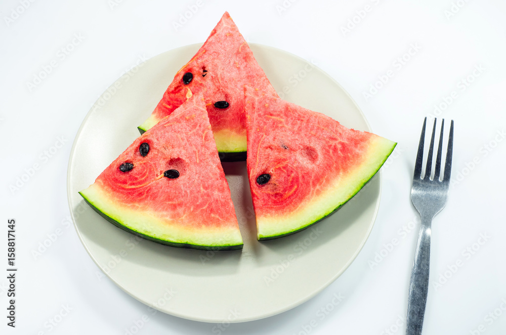 Watermelon slices put on the plate on white background Watermelon slices put on the plate on white background