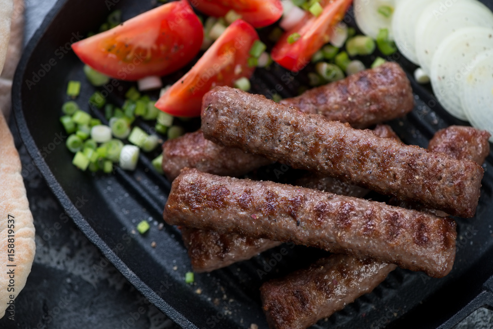 Close-up of barbecued cevapcici or skinless beef sausages, selective focus