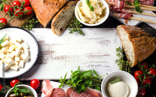 Various types of italian food on a wooden table