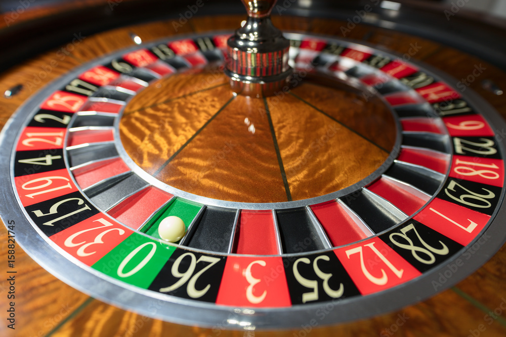 American Roulette wheel with a ball in the number '0' American Roulette wheel with a ball in the number '0'
