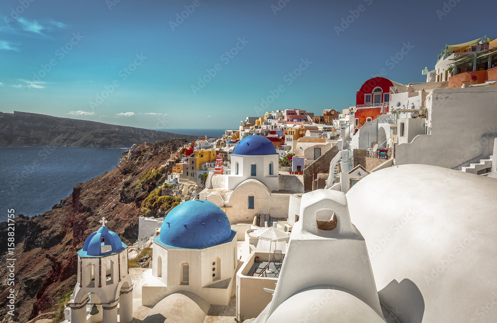 Santorini traditional blue dome churches on the cliff, Greece. Cyclades Islands. Vintage colors