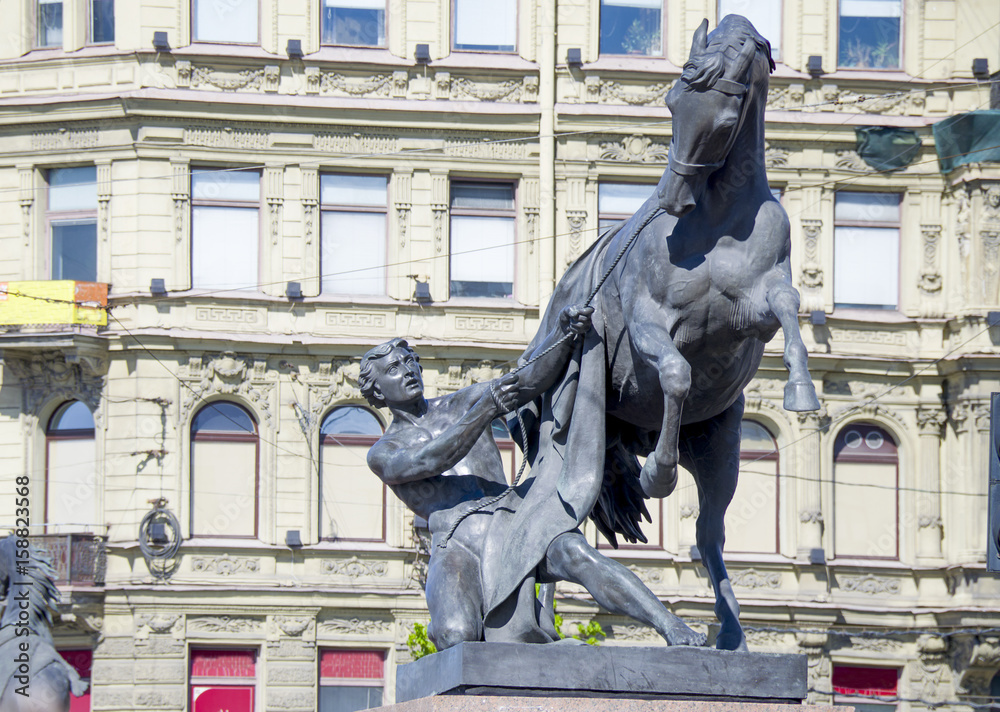Sculpture of the tamer of horses on Anichkov Bridge St. Petersburg in Russia the city
