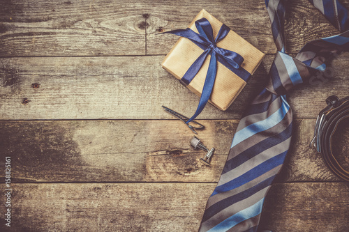Father's day concept - present, tie on rustic wood background