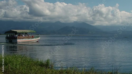 People taking boat trip on the beautiful Lake Yojoa nearby hotel Las Glorias in Honduras photo