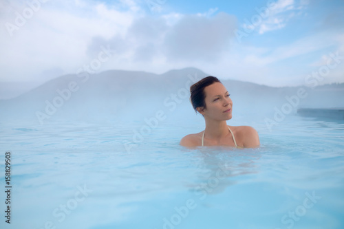 Woman enjoys spa in geothermal hot spring © Nejron Photo