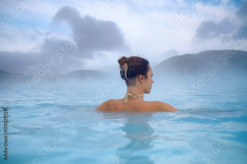 Woman enjoys spa in geothermal hot spring