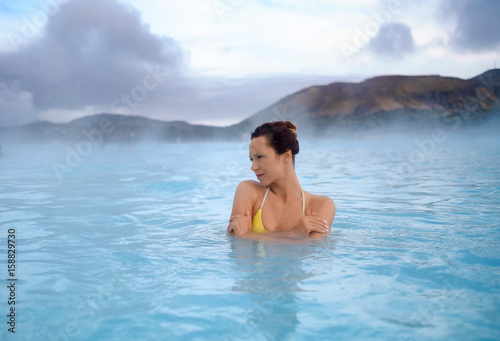 Woman enjoys spa in geothermal hot spring