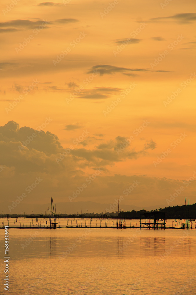View of Songkhla lake which has fish cage in water at sunset ; Koh Yor, Sonkhla province, Thailand
