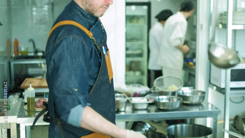 Chef of the restaurant prepares dishes in the kitchen. 4k Chef of the restaurant prepares dishes in the kitchen. 4k