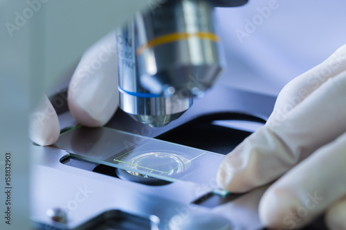 Scientist hands with microscope, examining samples, Concept science and Technology
