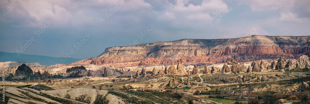 Colorful rose valley with dramatic sky in Cappadocia Colorful rose valley with dramatic sky in Cappadocia