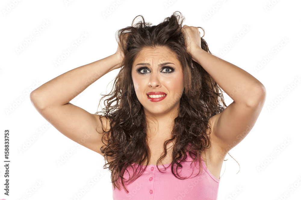 nervous young woman pulls her hair on white background nervous young woman pulls her hair on white background