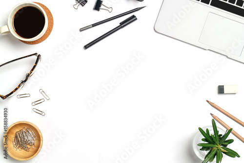 Top view workspace mockup on wood table with notebook, pen, coffee, clips and accessories.