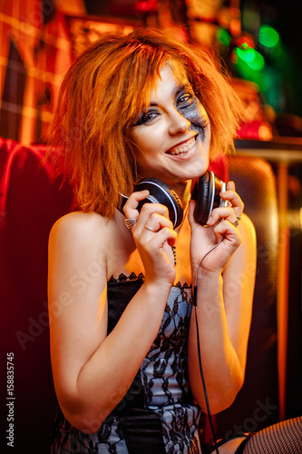 Girl in headphones at the disco
