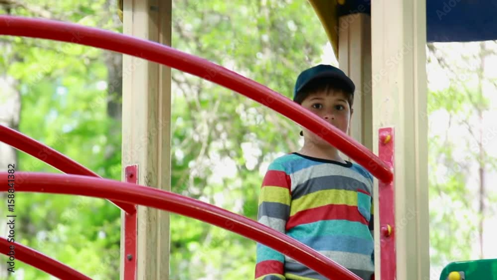 The boy climbs the ladder on the playground The boy climbs the ladder on the playground