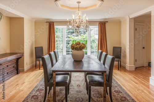 Elegant dining room with wood table and chandelier