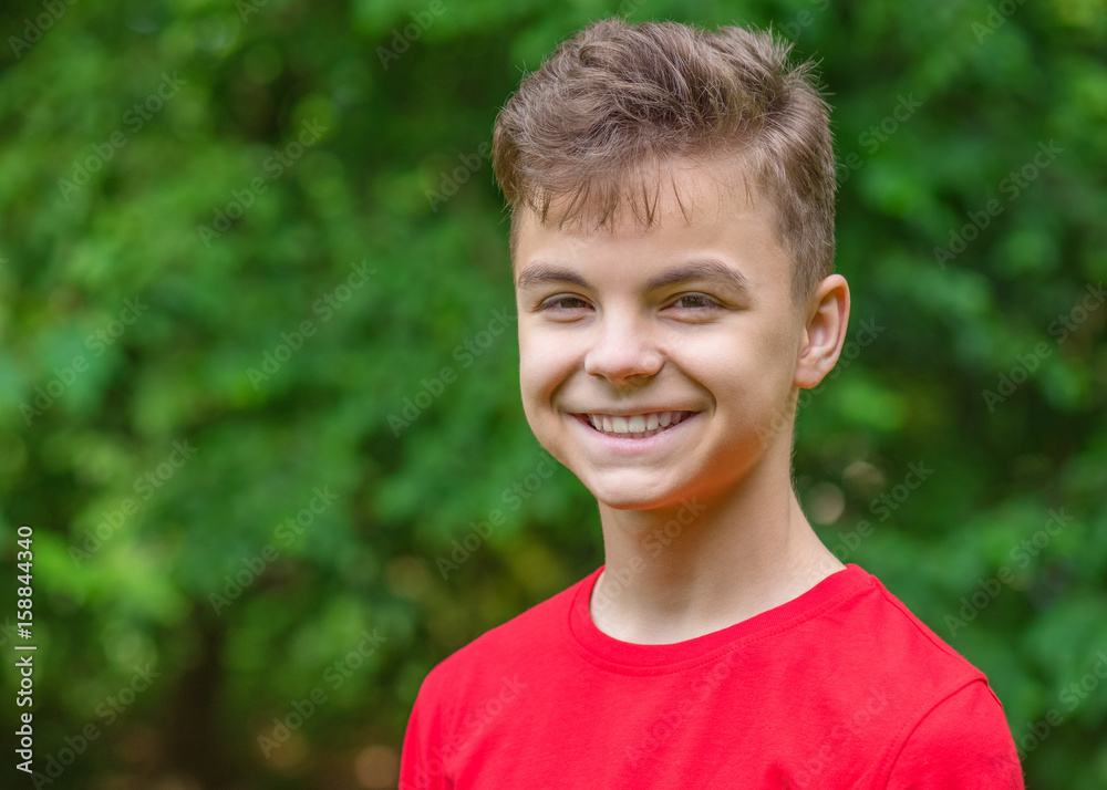 Close up emotional portrait of caucasian smiling teen boy. Head shot of handsome guy. Funny cute teenager in summer park at day. Child looking at camera. Close up emotional portrait of caucasian smiling teen boy. Head shot of handsome guy. Funny cute teenager in summer park at day. Child looking at camera.
